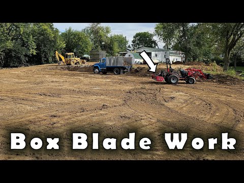 Using a box blade to level out some dirt in a future parking lot